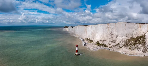 stock image A panorama view of the Beachy Head Lighthouse in the English Channel and the white cliffs of the Jurassic Coast