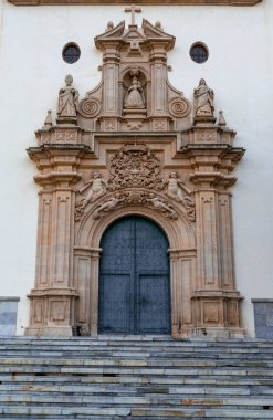 Murcia, Spain - 22 February, 2023: detail view of the ornate Baroque entrance and door of the Sanctuary of our Lady of the Holy Fountain in Murcia
