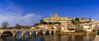 Beziers, France - 2 March, 2023: panorama view of the historic old town center of Beziers with Saint Nazaire Church and roman bridge over the river Orb clipart