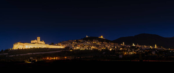 Assisi, Italy - 18 November, 2023: panorama nighttime view of the Basilica of San Francesco d'Assisi