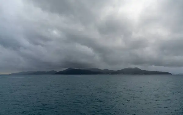 Horizontal landscape of Elba Island under an overcast and stormy sky