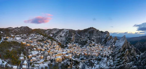 A drone panorama view of Castelmezzano at sunrise in winter
