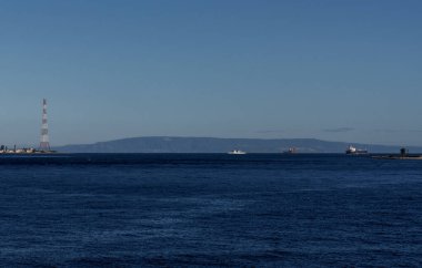 Villa San Giovanni, Italy - 17 December, 2023: view of the narrow Strait of Messina between Sicily and mainland Italy and ships passing clipart