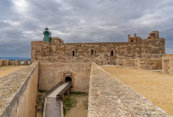 stock image Syracuse, Italy - 28 December, 2023: view of the Maniace Castle and lighthouse in Isola di Ortigia in Siracusa