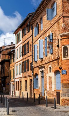 Albi, France - 18 April, 2024: picturesque city street in the historic city center of Albi with the typical red brick buildings clipart