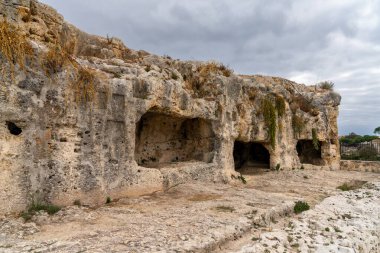 Syracuse, Italy - 28 December, 2023: view of the Caves of Nymphaeum in the Neapolis Archaeological Park in downtwon Syracuse clipart