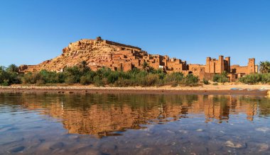 Ait Benhaddou, Morocco - 14 March, 2024: panorama landscape of Ait Benhaddou village with reflections  in the Asif Ounila River clipart