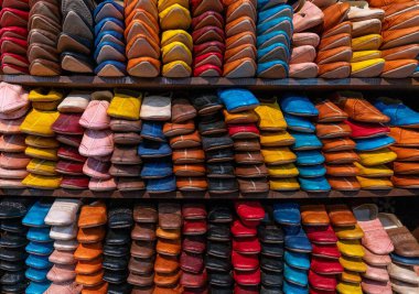 Fez, Morocco - 4 March, 2024: detail view of shelves full of colourful leather shoes and slippers in the medina of Fez near the Chouara Tannery clipart