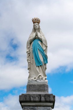 Lourdes, France - 17 April, 2024: view of the Our Lady of Lourdes statue in front of the sanctuary clipart