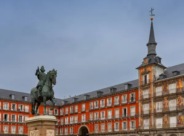 stock image Madrid, Spain - 6 April, 2024: statue of Felipe II and the landmark buildings of the Plaza Mayor city square in downtown Madrid