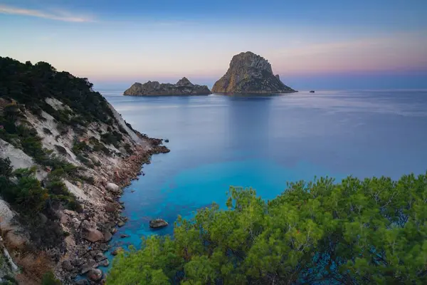 stock image A view of the landmark Es Vedra island and rocks off the coast of Ibiza at sunrise