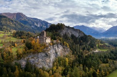 view of the Ortenstein Castle in the Domleschg Valley in southeastern Switzerland in late autumn clipart