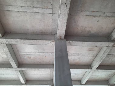 Tamamlanmamış bir binada güçlendirilmiş beton sütun ve kiriş yapısı biçimsel izler ve yapısal hizalama gösteriyor. Beton yapı, inşaat mühendisliği ve inşaat ilerleme teması için uygun