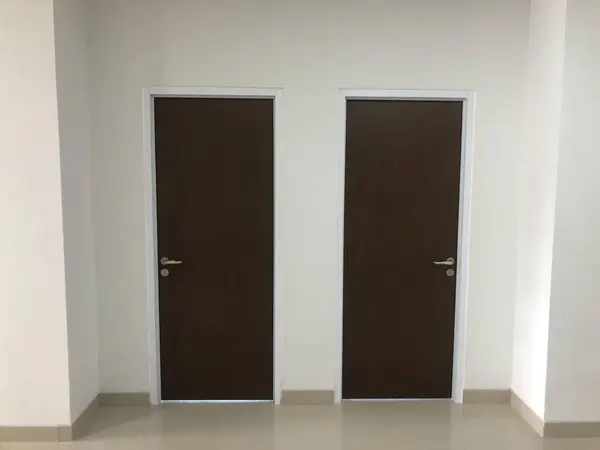 Minimalist ikiz ahşap kapılar temiz bir iç koridorda, ofis için ideal daire konsepti görseller, mimari veya gayrimenkul içeriği