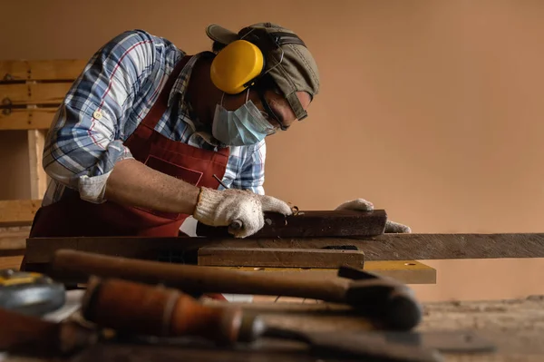Carpintero Que Trabaja Duro Mientras Que Cepilla Madera Con Una —  Fotos de Stock