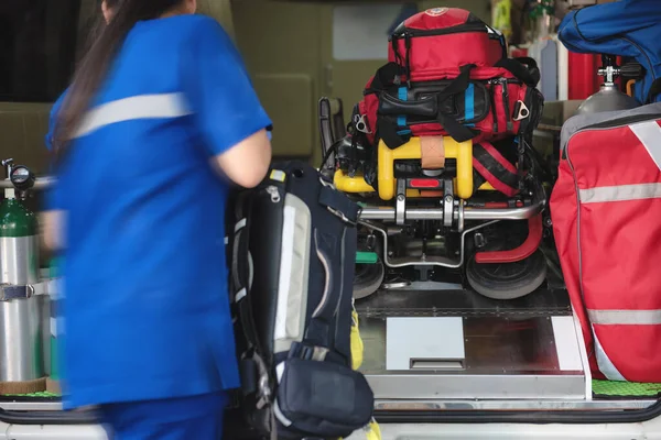 stock image Emergency medical team service rescuing was rushing to get the equipment into the ambulance car. Selective focus on first aid bags or equipment in the car.