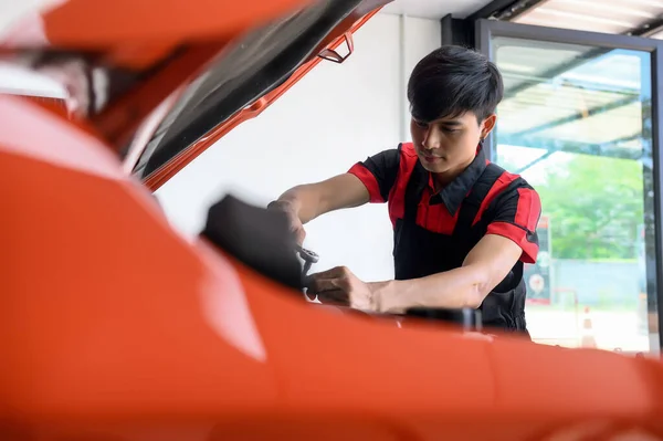 Car Maintenance and Repair, Expert Car Maintenance Service, Mechanic Working on the Engine of Car in the Garage, Keeping Vehicle in Top Shape, Trusted Car Maintenance Service for Optimal Performance.