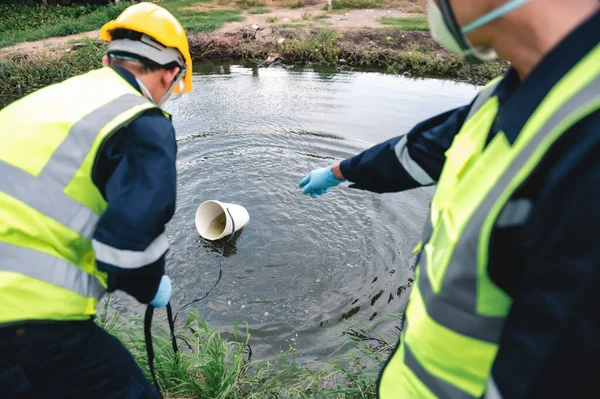 Environmental Engineers Take Water Samples at Rotten Smelly Pond Water Sources, May Be Contaminated by Toxic Waste or Suspicious Pollution Sites.
