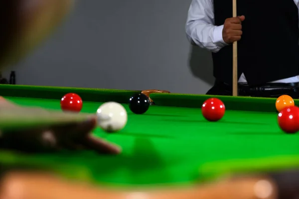 Pockets at the edge of snooker table is goal of black ball. Selective focusing on pockets of snooker table