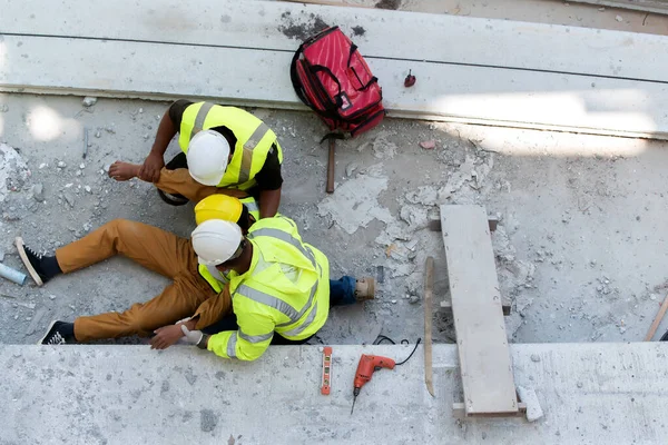 Heat Stroke or Heat exhaustion in body while outdoor work. Accident at work of builder worker at Construction site. Lifesaving, rescue, first aid basic concept.