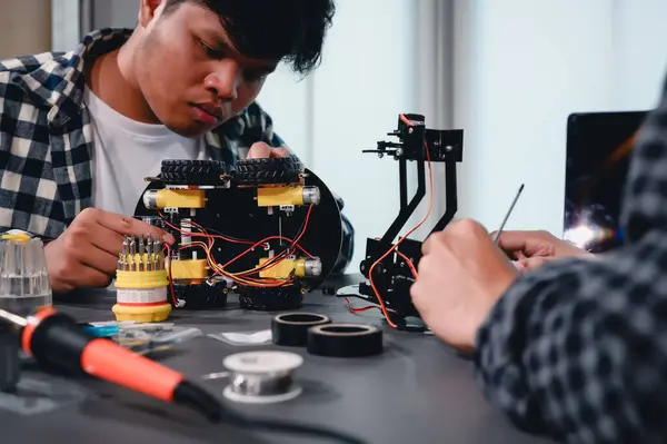 stock image Engineer Asian Students Assembling Robotics Kits. Learning Mechanical Control, Robotics combines computer, electrical, mechanical, and sensing. Empowering Engineers and Development Concept.