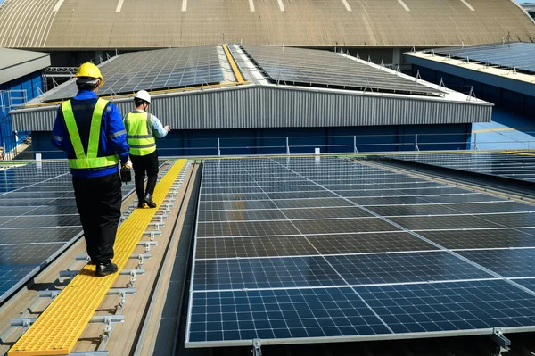 Engineer Inspector Quality in Solar Roof Panel Installation with Worker Installation, Overview of Quality Control in Work of Sustainable Photovoltaic Installation on Factory Roof Buildings.