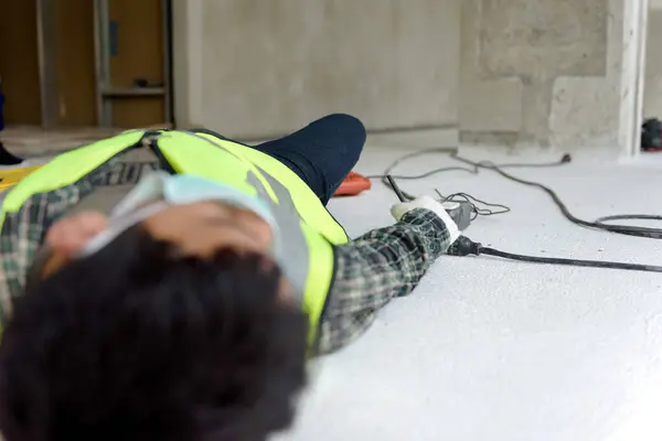 Work accident electric short circuit to a worker in the workplace and Unconscious lying on the floor after hand connecting power outlet to an electric tool with no electrical plug.