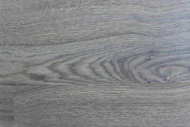 Gri-kahverengi ahşap doku: Ahşap halkalar ve damarların doğal desenine sahip bir yüzey sıcaklık ve doğal estetik duygusu yaratır. Fotoğraf eko ya da rustik tarzı iç mekanlar için mükemmel..