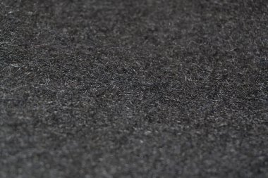 Siyah yün dokusu: koyu siyah renkli yumuşak yün kumaştan yakın çekim. Siyah yün kumaş. Üniforma dokusunda karmaşıklık ve zarafet var..