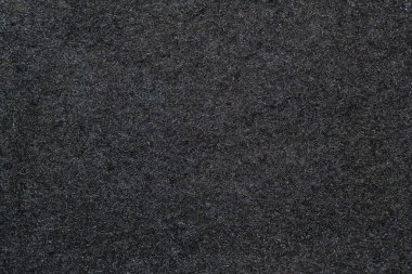 Siyah yün kumaş: pürüzsüz ve düz desenli siyah yün kumaş detaylı bir görünüm. Siyah yün dokusu: Zengin siyah ton kumaşın çok yönlülüğünü ve zamansızlığını vurgular.