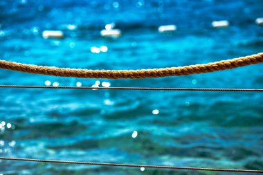 A detailed macro shot of a dock rope, showcasing the intricate fibers and textures of the tightly woven strands, perfect for nautical and marine themes.