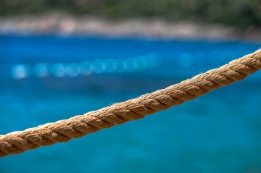 A detailed macro shot of a dock rope, showcasing the intricate fibers and textures of the tightly woven strands, perfect for nautical and marine themes. clipart