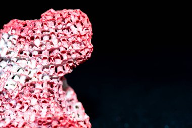 A detailed macro photograph highlighting the intricate textures of a red coral reef set against a black background, showcasing its vibrant beauty. clipart