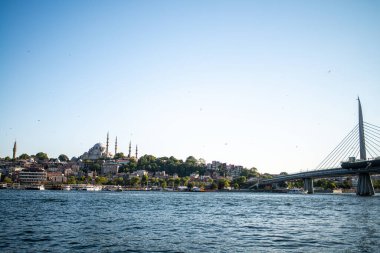 Istanbuls Boğazı ve Hali 'nin manzaralı güzelliğini yansıtan bir fotoğraf, canlı şehir manzarasını, köprüleri ve hareketli rıhtımı gözler önüne seriyor.