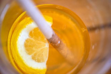 A close-up macro photo capturing the vibrant and refreshing essence of a cocktail garnished with a slice of lemon. clipart