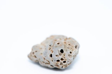 Beyaz zemin üzerine yerleştirilmiş pürüzsüz, renkli çakıl taşlarının yakın çekim makrosu doğal dokularını ve karmaşık ayrıntılarını gözler önüne seriyor..