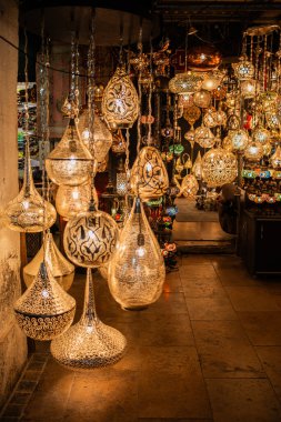 Bask in the enchanting glow of vibrant lanterns in the bazaar, a magical display of traditional crafts, handmade treasures, and artisanal elegance, creating an atmospheric and festive ambiance. clipart