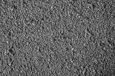 A detailed close-up photo capturing the gritty texture of urban asphalt, highlighting the rugged beauty of a well-traveled city road. clipart