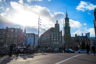 Amsterdam streets come alive with festive lights and a cheerful atmosphere just before the New Year, capturing the lively city's spirit. clipart