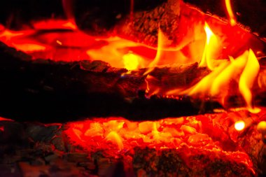 Capture the essence of inferno with a close-up of fiery wood fire, showcasing blazing flames and scorching heat. clipart