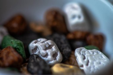 Macro photo of colorful pebble chocolates, showcasing the vibrant details and delicious textures of these unique, playful treats. clipart