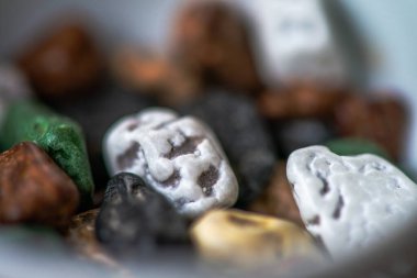 Macro photo of colorful pebble chocolates, showcasing the vibrant details and delicious textures of these unique, playful treats. clipart