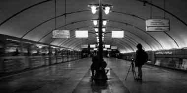 Modern underground metro station captured in monochrome, highlighting its clean lines, symmetry, and ambient lighting. clipart