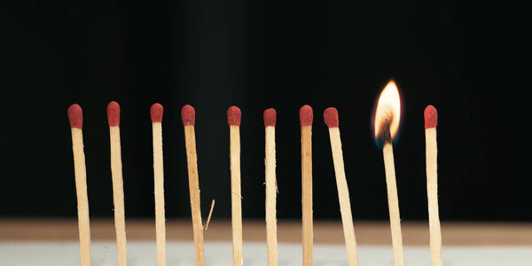 burning match on a black background