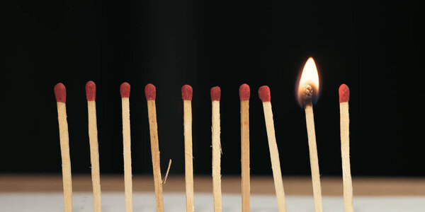burning candles on black background.