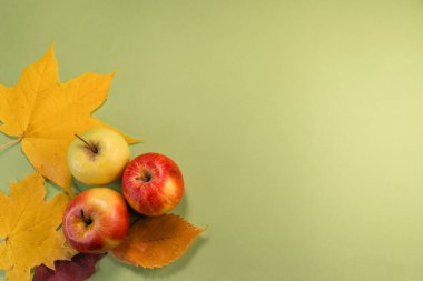 autumn background. apples and leaves on the table. top view with copy space