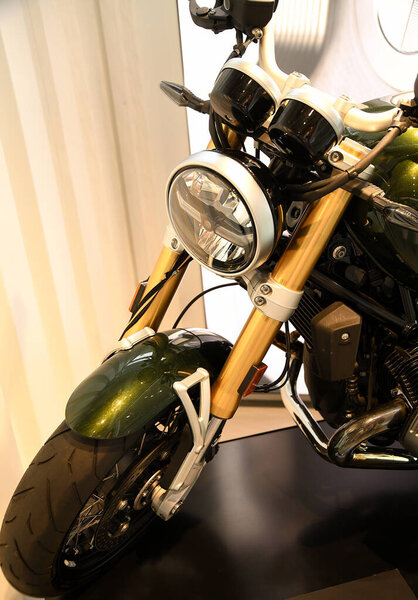 close-up of the front of the motorcycle. The central place is occupied by a round headlight surrounded by a chrome trim.