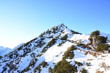 majestic mountain range covered with snow. The bright sun illuminates the snow-capped peaks and slopes clipart