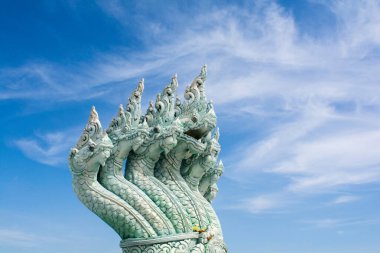 Thai dragon, king of naga statue with blue sky background. clipart