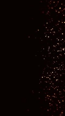 Siyah zemin üzerinde altın tozu şeklinde küçük parçacıkların yavaş hareketi Hd